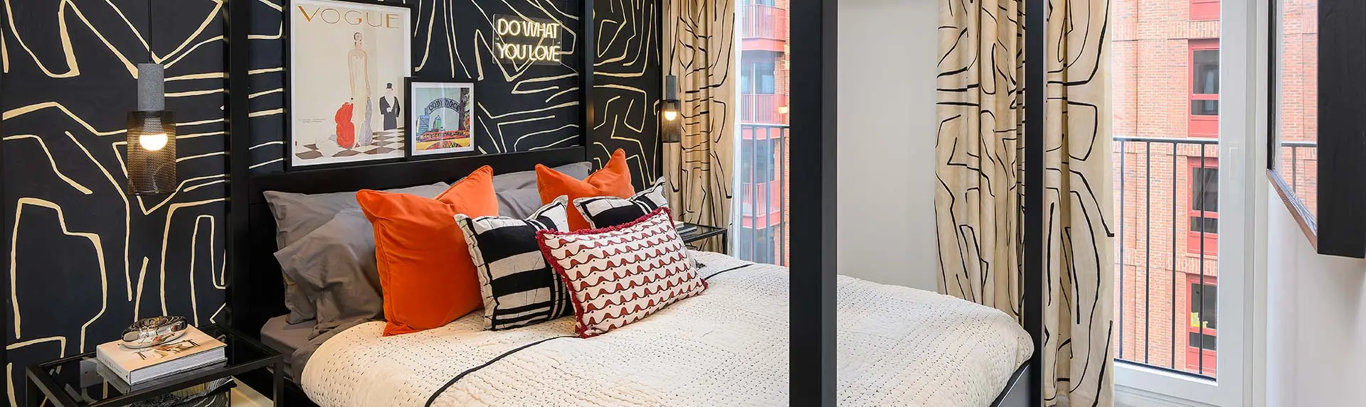 Cosy bedroom at Heron Wharf with bold feature wall