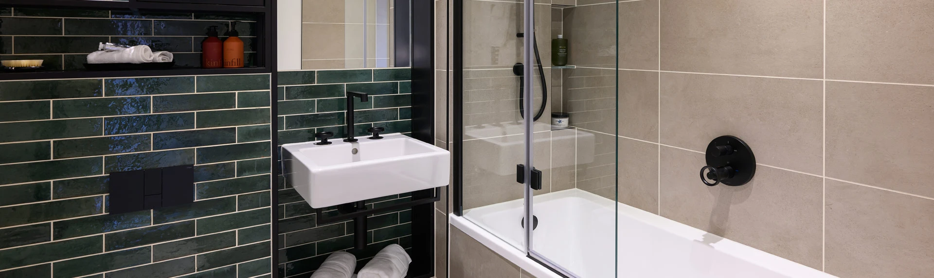 Modern bathroom at Heron Wharf featuring stylish tiling