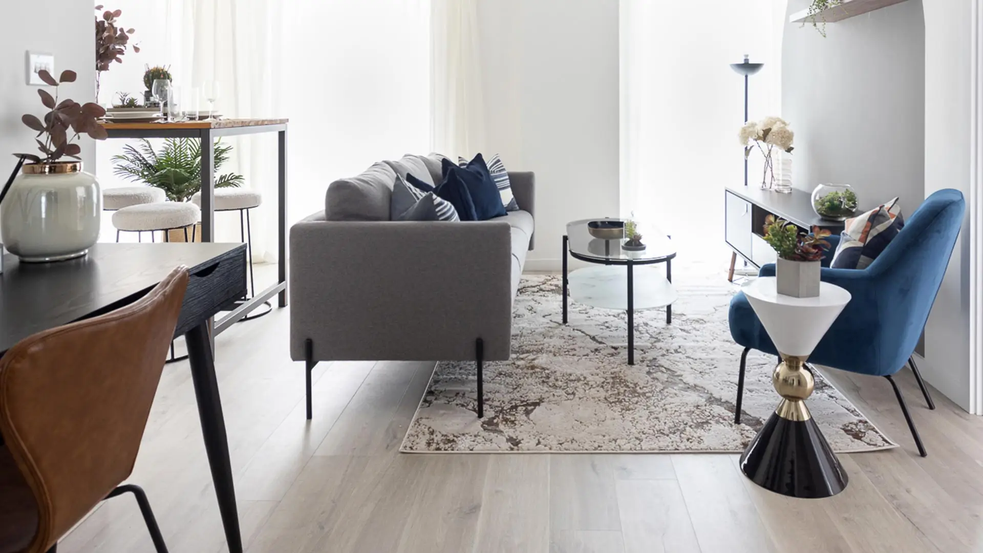 Minimalist dining and lounge area featuring our packages, perfect for sophisticated urban lifestyles and modern interiors.